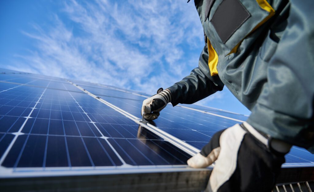 Male worker repairing photovoltaic solar panels