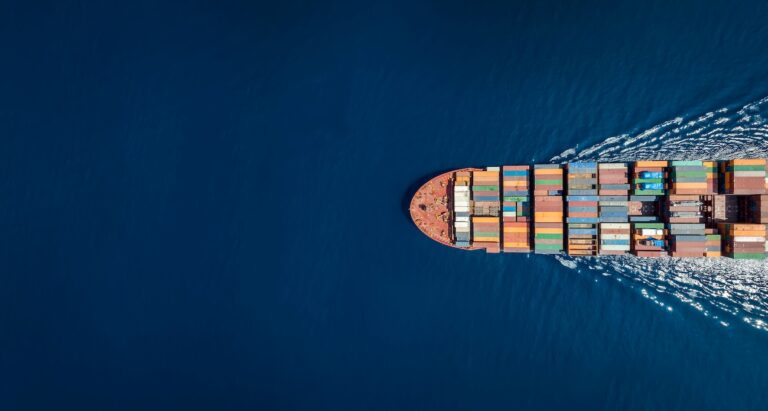 Aerial top down view of a large container cargo ship in ocean representing cargo and freight insurance company