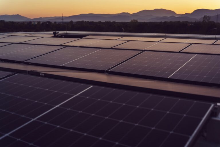 solar panels on roof at sunset representing renewables