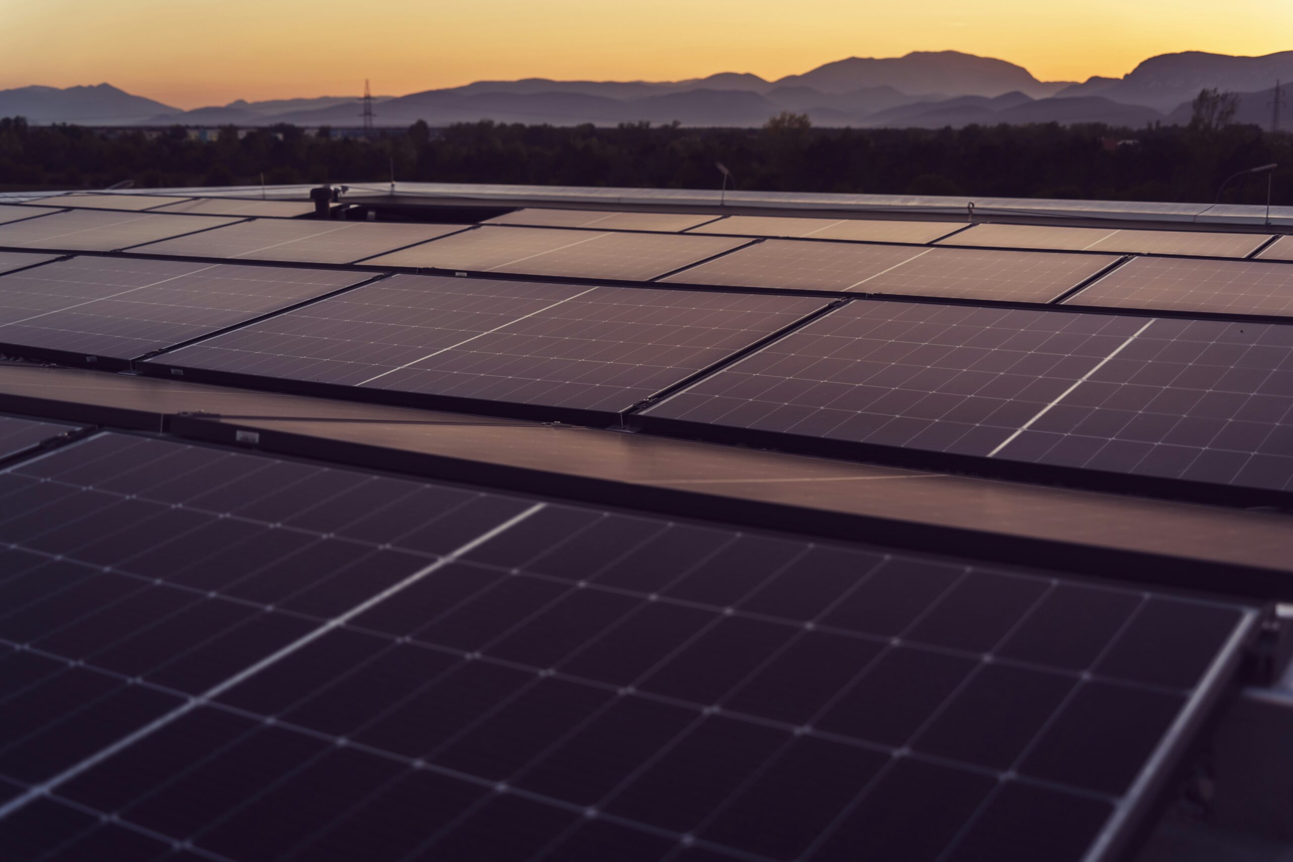 solar panels on roof at sunset representing renewables