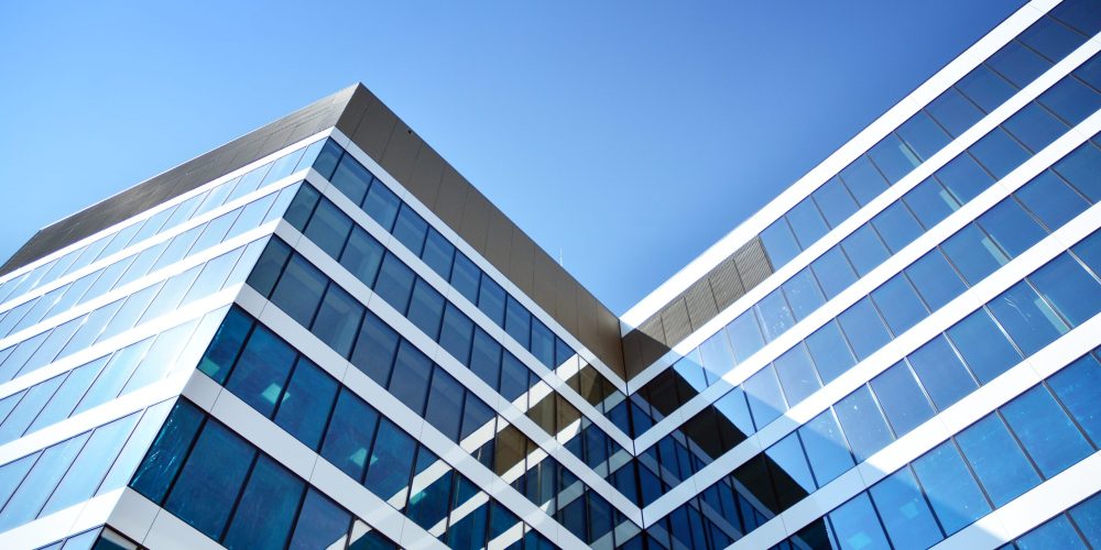 New office building in business center. Wall made of steel and g New office building in business center representing corporate