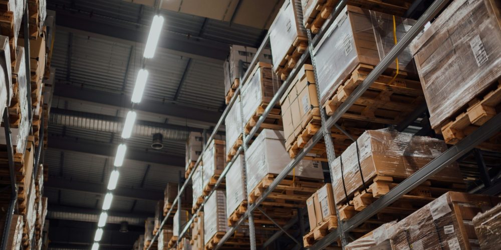 chuttersnap-BNBA1h-NgdY-unsplash cardboard boxes on shelves in warehouse representing wholesalers
