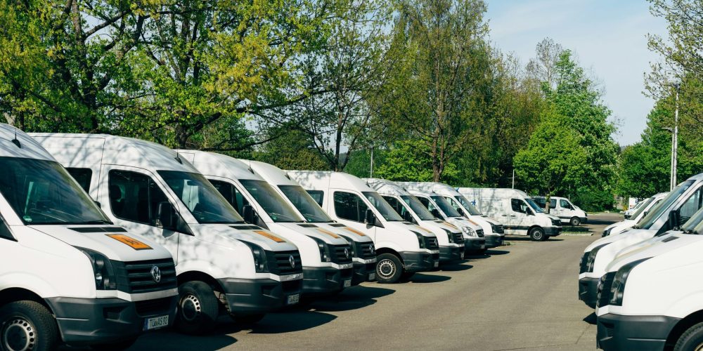markus-winkler-3vlGNkDep4E-unsplash fleet of white vans representing transport